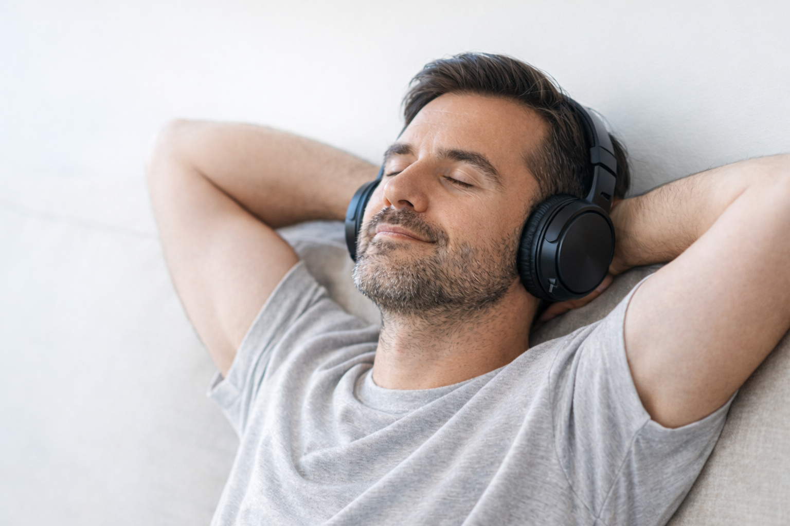 Calm man wearing headphones listening peacefully