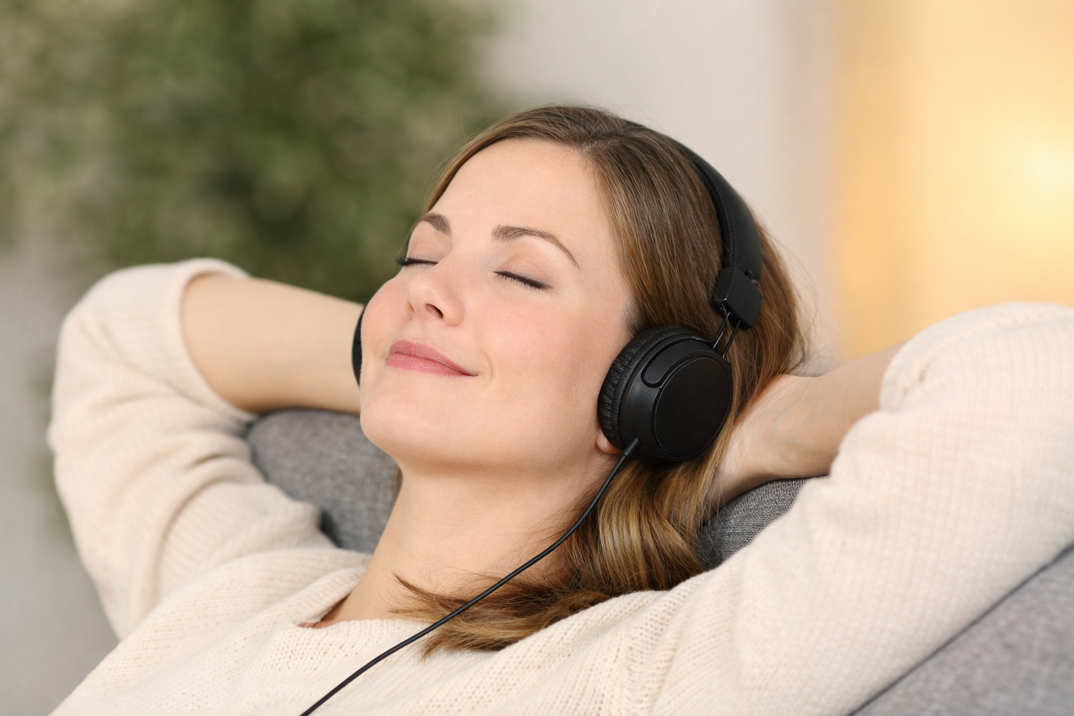 Person listening calmly with wired on-ear headphones